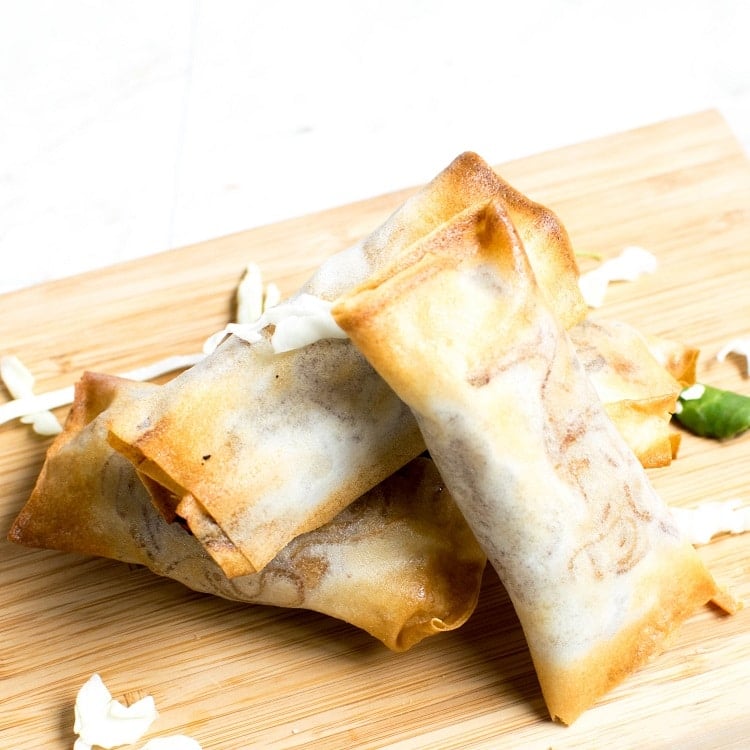 Air Fryer Vegan Spring Rolls displayed on a wooden board