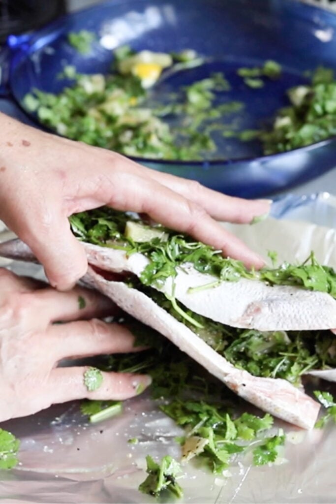 adding spices above and under the fish