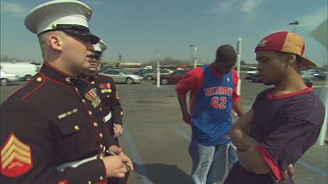 Marine recruiter in Flint, Mich. approaching teenagers outside a shopping mall to enlist them in the military.