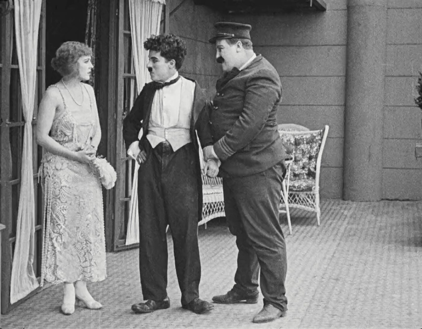 Charles Chaplin, Frank J. Coleman, and Edna Purviance in The Adventurer (1917)