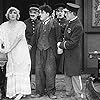 Charles Chaplin, George Cleethorpe, Fred Goodwins, Edna Purviance, and Leo White in Police (1916)