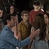 Carla Gugino, Henry Thomas, Mckenna Grace, Lulu Wilson, Julian Hilliard, Paxton Singleton, and Violet McGraw in The Haunting of Hill House (2018)