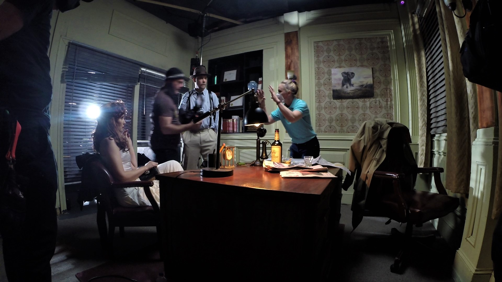 Christy Oldham directs actors Shane Woodson and Leni Rico on set of the film noir "A Pyrrhic Victory".