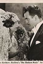 Barbara Bedford and Wheeler Oakman in The Broken Mask (1928)