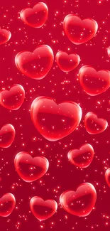 Romantic wallpaper with glowing red hearts and sparkles against a red background.