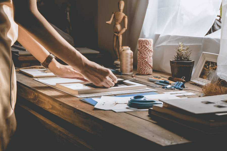 photo of person doing project on desk