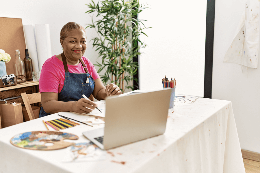 photo of woman drawing with laptop