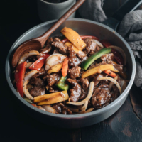 Restaurant-style black pepper steak that is tender, juicy and rich, with crisp veggies and a scrumptious sauce that goes perfectly with steamed rice. {Gluten Free Adaptable}