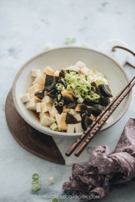 Century egg with tofu salad garnished with green onions