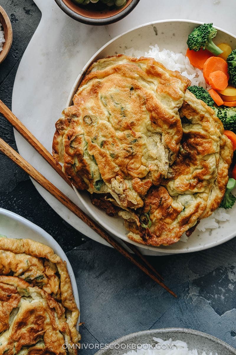 Homemade egg foo young served on steamed rice