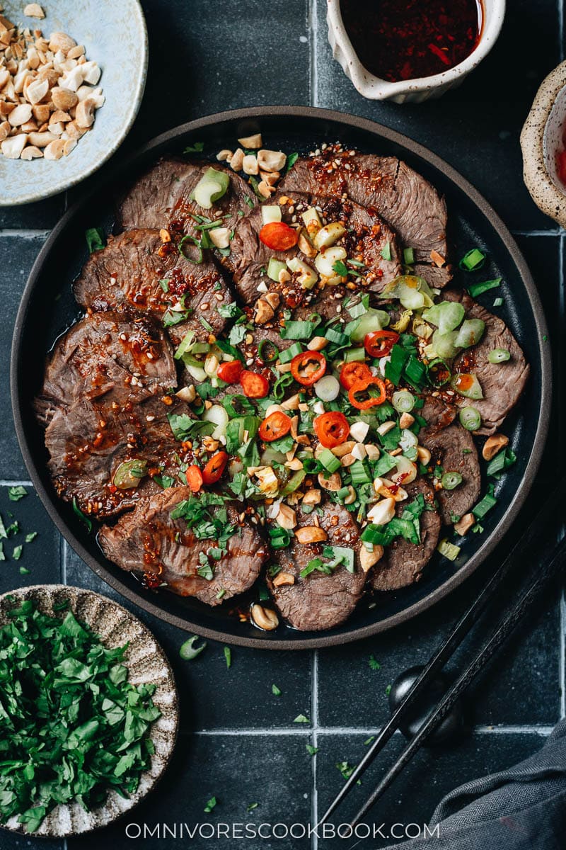 Sliced braised beef shank served with dressing and vegetables