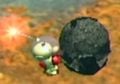 A screenshot of Captain Olimar holding a bomb-rock.