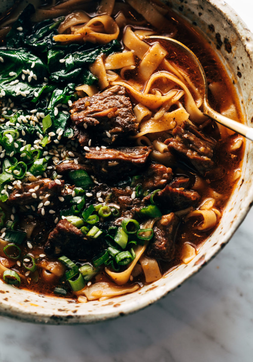 Short rib noodle soup in a bowl with a spoon