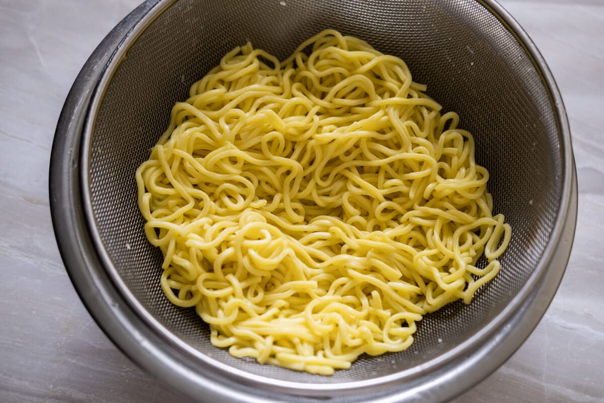 Egg noodles in a colander.