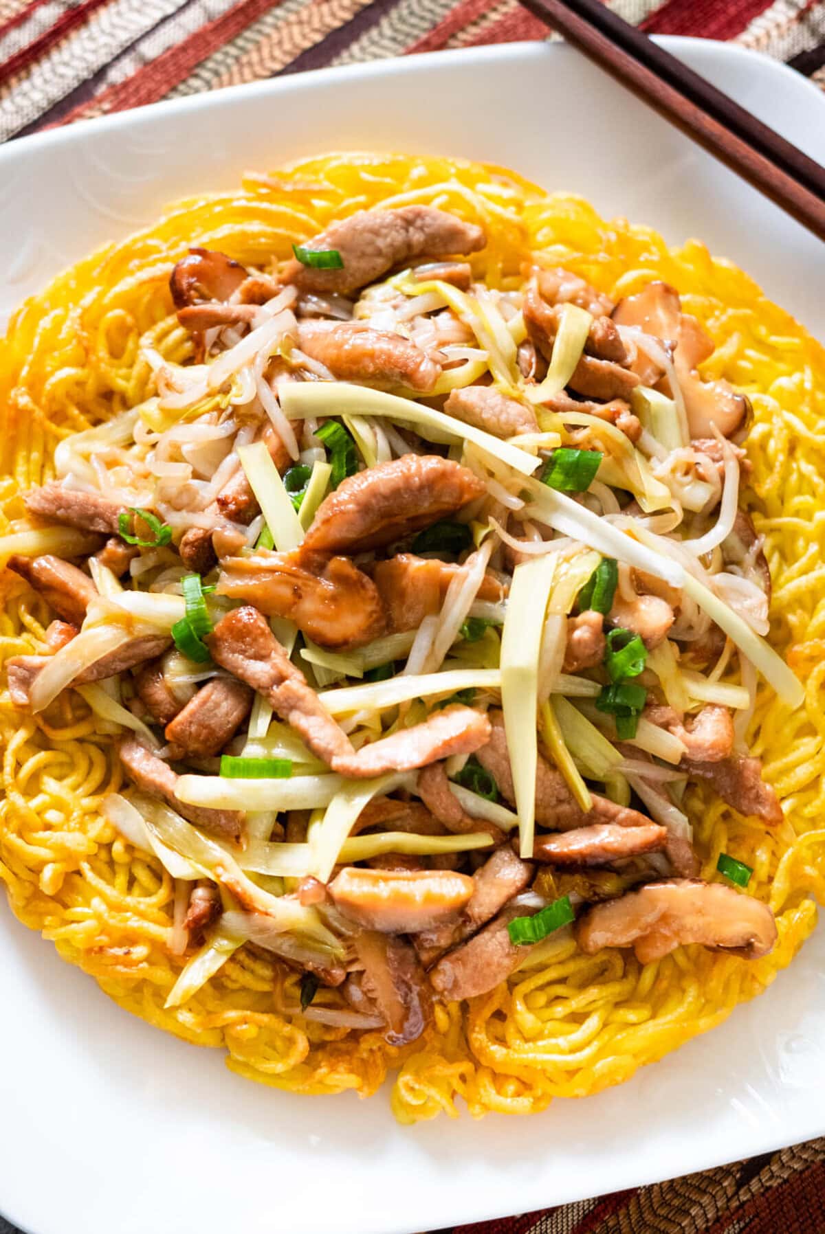 Pork chow mein, a classic Chinese food dish with crispy egg noodles, pork and chow mein sauce.