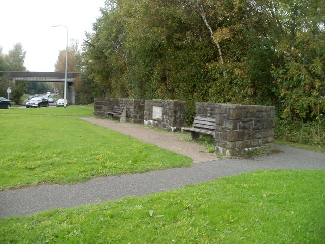 Two benches and three low stone walls opposite Forge Hammer roundabout, Cwmbran