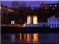 NZ2563 : 'Rise & Fall' & Brett's Oil tanks at night by Andrew Curtis