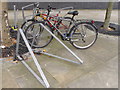 TQ3282 : Cycle racks with locks left by commuters by David Hawgood