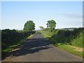 NU0041 : Country road towards Kentstone and Beal by Graham Robson