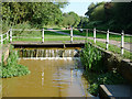 SJ8354 : Lock overflow channel by Harding's Wood, Staffordshire by Roger  D Kidd