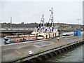 SJ3680 : Tugs moored in the sluiceway, Eastham Locks by Christine Johnstone