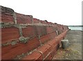 NX0883 : Weather-worn harbour wall by Ann Cook