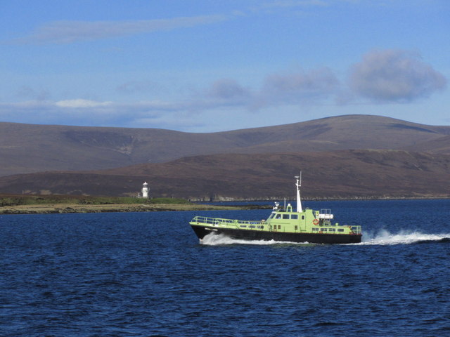 MV Hoxa Lass between Houton & Flotta. view to Calf of Cava Lighthouse