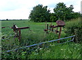 SP4085 : Old farm machinery next to the B4065 Leicester Road by Mat Fascione