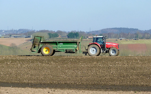 Tractor pulling muck spreader near Worfield, Shropshire