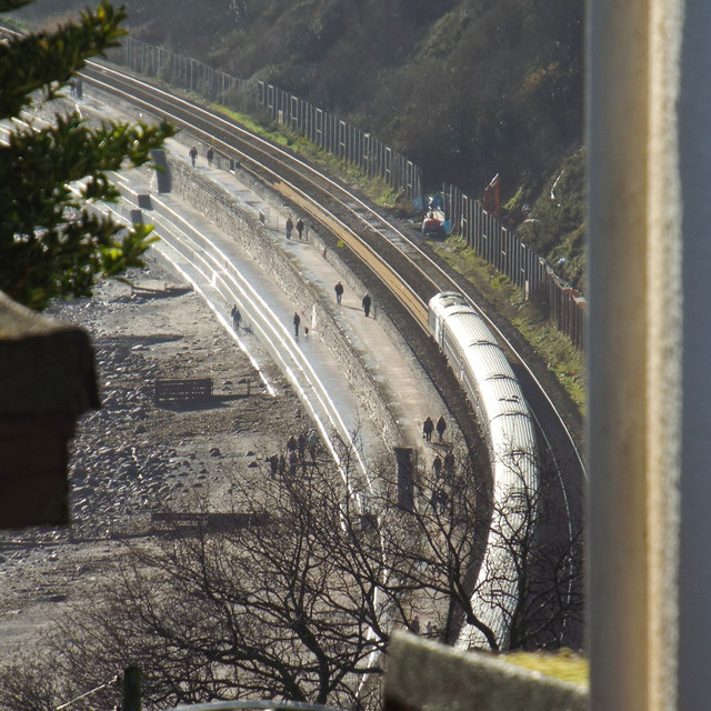 A glimpse of the railway and the sea wall promenade below Holcombe