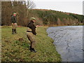 NJ2442 : An angler plays a fish by the hut at Dellagyle by Des Colhoun