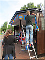 SP9211 : Putting up the yarn fringe round the roof of Tring's Bus Shelter by Chris Reynolds