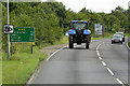 TF9130 : Tractor on the A148 near Fakenham by David Dixon