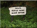 TM1239 : Bentley Manor & Manor Cottage sign by Geographer