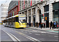 SJ8498 : Metrolink Tram Passing The Printworks by David Dixon