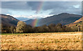 NN1827 : Sunlit field on north side of A85 by Trevor Littlewood