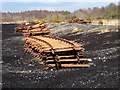 N1621 : Rails stacked beside the peatland light railway by Oliver Dixon