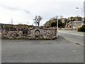 SH7980 : Wall and drinking fountain at Llanrhos by Gerald England