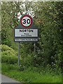 TL9565 : Norton Village Name sign on the A1088 by Geographer