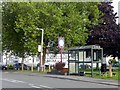 SK3030 : Bus shelter and Millennium sign by Graham Hogg