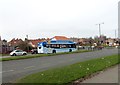 NZ3754 : Bus at a road junction by Robert Graham