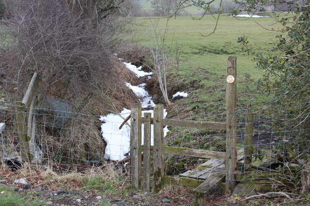 Snowy stream and stile