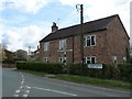 SE6754 : Contrasting signposts at the northern end of Holtby village by Christine Johnstone