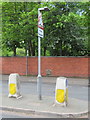 SJ3350 : Traffic island and milepost in Chester Road, Wrexham by John S Turner