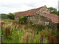 NZ8803 : Footpath passing a farm building, Leas Head Farm by Humphrey Bolton