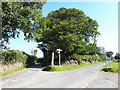 SX5371 : Road junction near Huckworthy Common, with stone cross and signpost by Vieve Forward