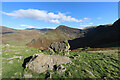 NY1813 : Boulders by the Scarth Gap Pass bridleway, looking to Fleetwith Pike by Andy Waddington