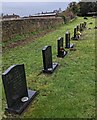 ST4690 : Row of black headstones, Caerwent by Jaggery