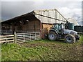 SJ5619 : Tractor and barn at Little Wytheford Farm by TCExplorer