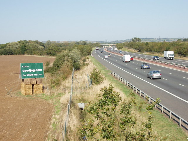 Billboard advertising by M40 motorway, near Waterperry Common